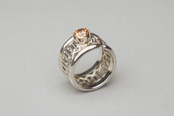 Chained, 2022.  Created with fabrication and CAD (3D modelling), this ring is made of sterling silver, copper, and cubic zirconia.    2.2 x 2.6 x 1.3cm (SIZE: US 7)