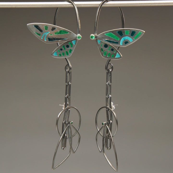 Cicada Wings, 2023.  Created with hand fabrication and enamelling, these earrings are made of sterling silver, fine silver, recycled silver, enamel, and cubic zirconia.  12 x 2.9 x 3cm