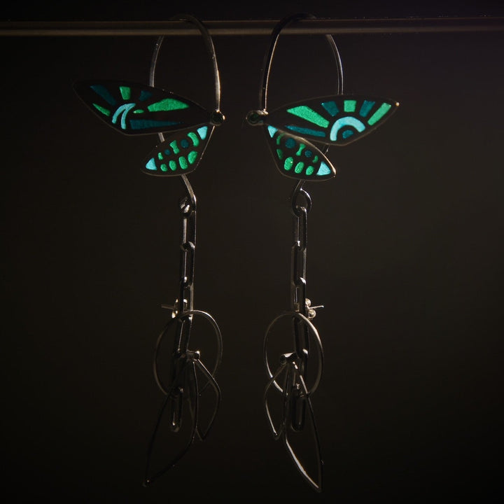 Cicada Wings, 2023.  Created with hand fabrication and enamelling, these earrings are made of sterling silver, fine silver, recycled silver, enamel, and cubic zirconia.  12 x 2.9 x 3cm