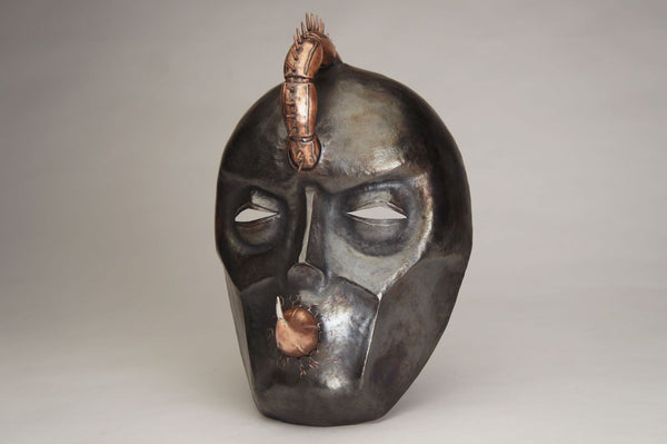 Hothead, 2022.  Created with hand fabrication, chase and repousse, and spiculum forming, this mask is made of copper and silver.  18 x 26 x 14cm