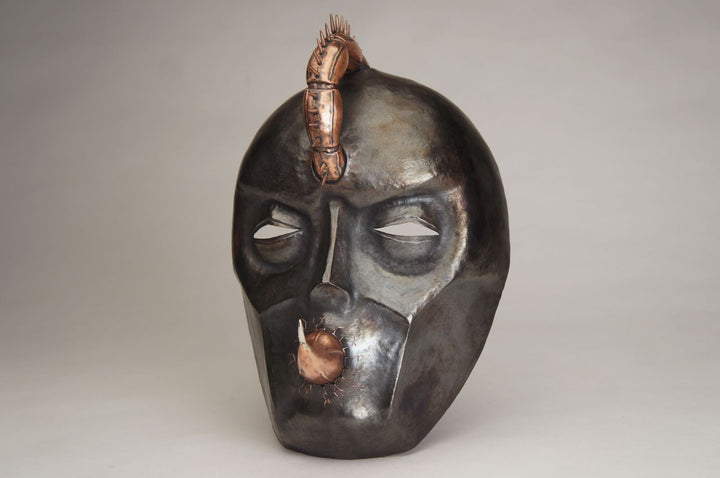 Hothead, 2022.  Created with hand fabrication, chase and repousse, and spiculum forming, this mask is made of copper and silver.  18 x 26 x 14cm