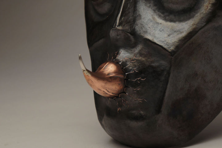 Hothead, 2022.  Created with hand fabrication, chase and repousse, and spiculum forming, this mask is made of copper and silver.  18 x 26 x 14cm