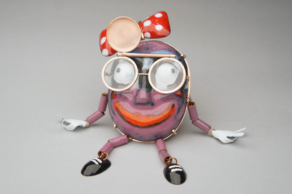Mr. Trashface, 2023.  Created with hand fabrication, chase and repousse, and enamelling, this brooch is made of copper, enamel, acrylic, brass, and steel.  16 x 8 x 2.4 cm