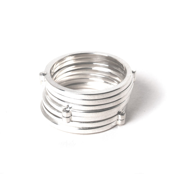 Silver ring with multiple bands on a white background