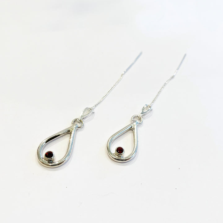 Vermilion Bird(朱雀) Earring version 1, 2023.  Hand fabricated sterling silver earrings with red garnets.