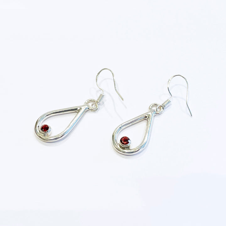 Vermilion Bird(朱雀) Earring version 2, 2023.  Hand fabricated sterling silver earrings with red garnets.