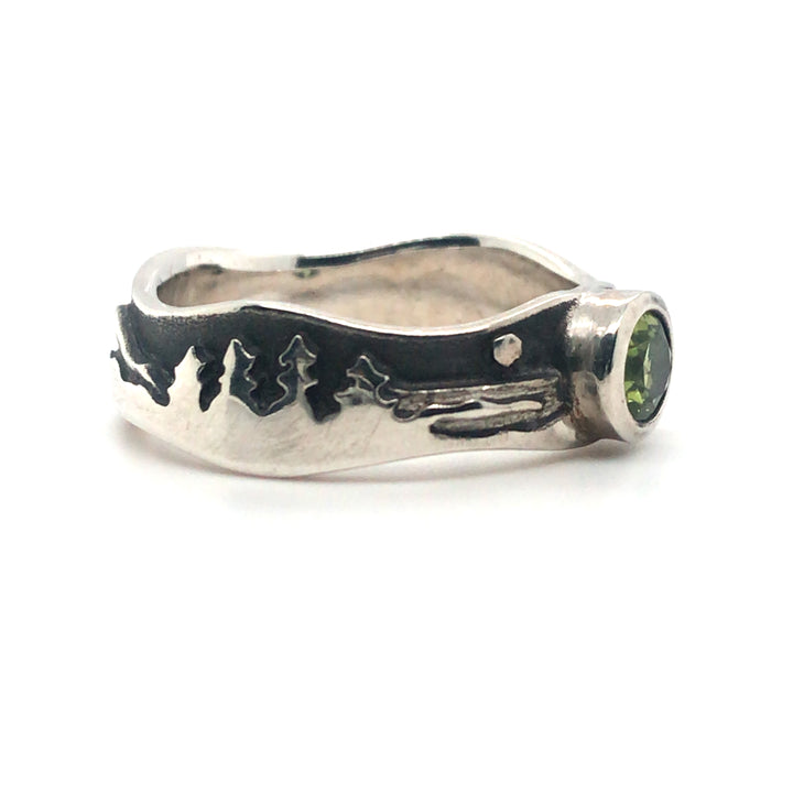 Peridot landscape at night ring in polished sterling silver against the oxidized matte black sky