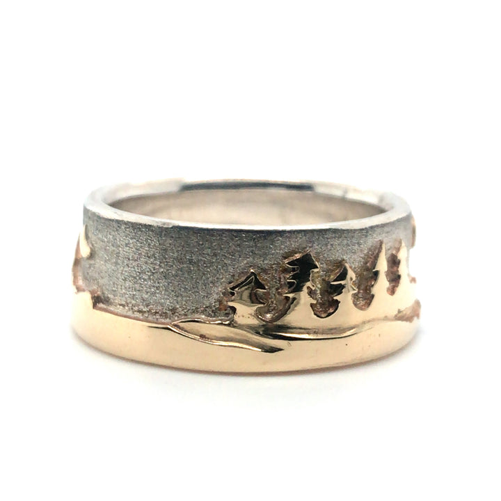 Two tone Shoreline Ring with a brushed sterling silver sky backdrop for the rugged mountains with moon, and sun above the trees and lake in impressive depths of polished 14k yellow gold. 