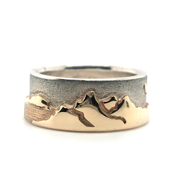 Two tone Shoreline Ring with a brushed sterling silver sky backdrop for the rugged mountains with moon, and sun above the trees and lake in impressive depths of polished 14k yellow gold. 