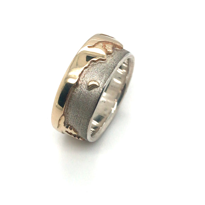 Two tone Shoreline Ring with a brushed sterling silver sky backdrop for the rugged mountains with moon, and sun above the trees and lake in impressive depths of polished 14k yellow gold. 