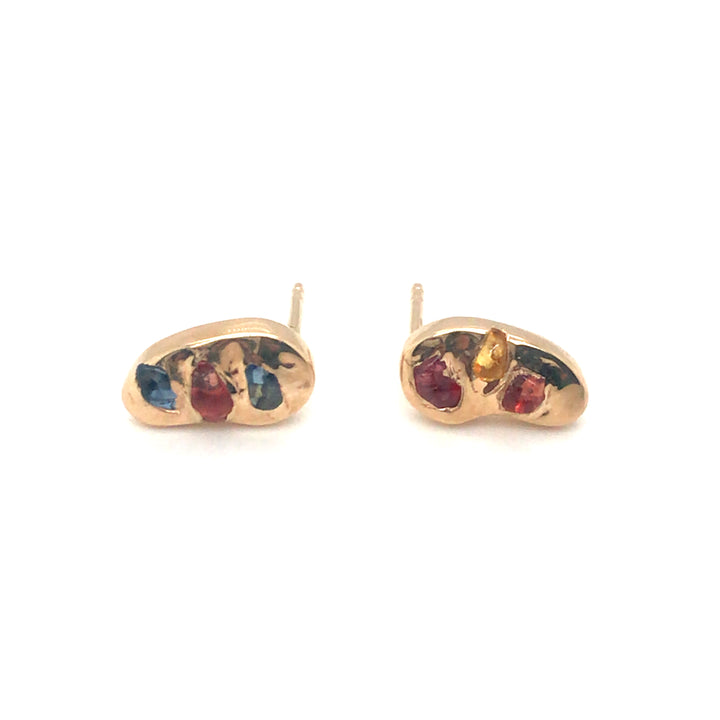 Asymmetrical 14k stud earrings gorgeously studded with colourful rough sapphires.