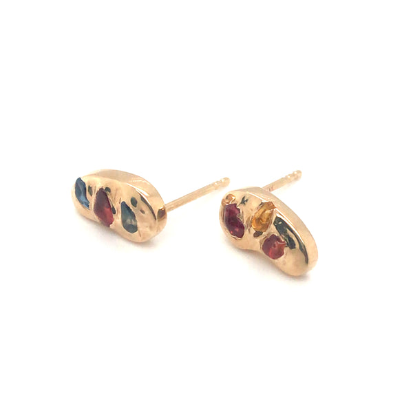 Asymmetrical 14k stud earrings gorgeously studded with colourful rough sapphires.