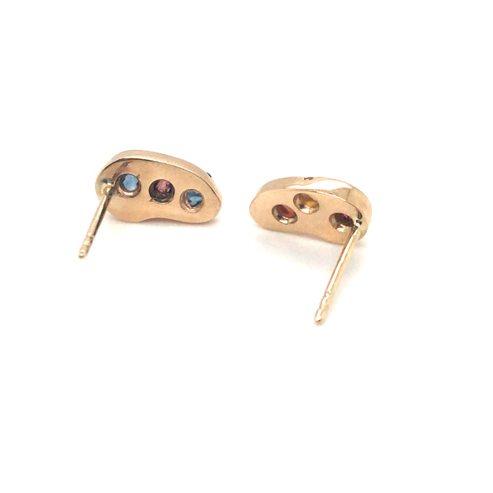 Asymmetrical 14k stud earrings gorgeously studded with colourful rough sapphires.