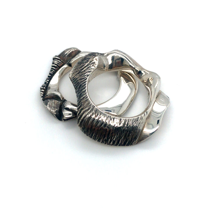 Pair of cast sterling silver rings.