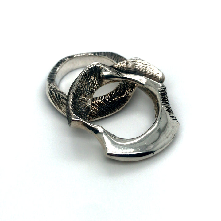 Pair of cast sterling silver rings.