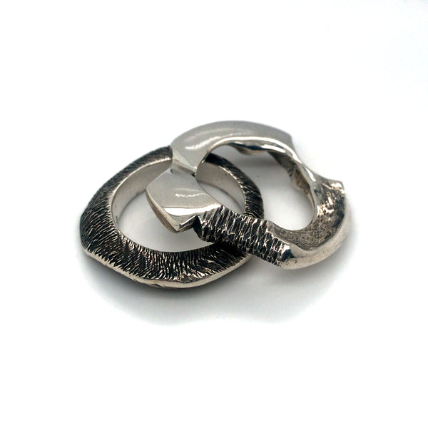 Pair of cast sterling silver rings.
