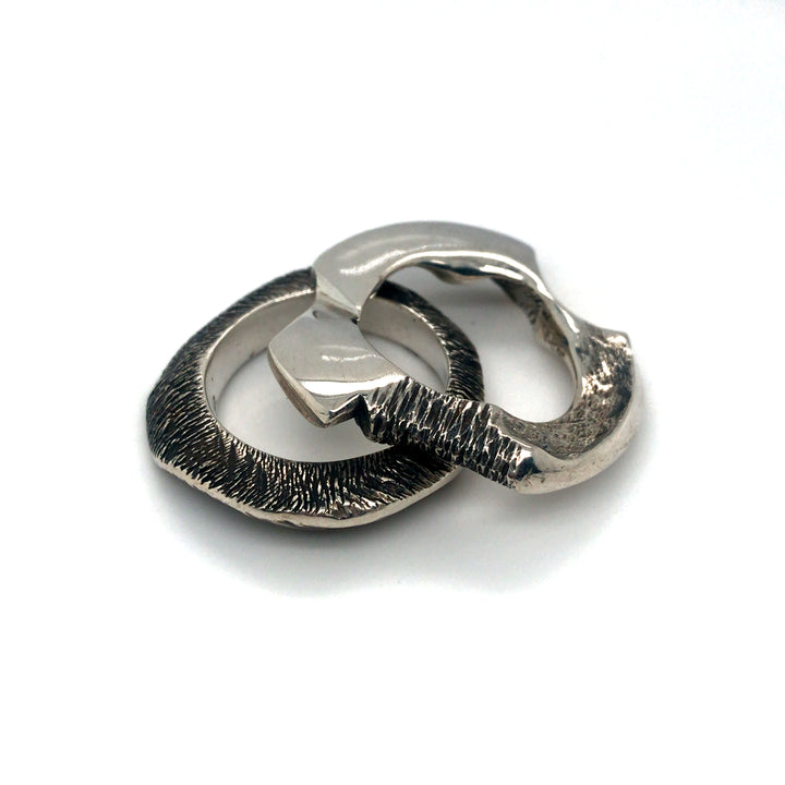 Pair of cast sterling silver rings.