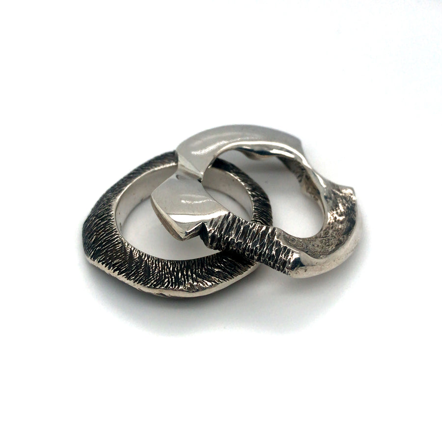 Pair of cast sterling silver rings.