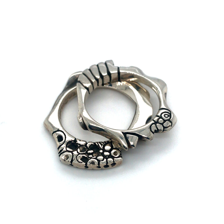 Pair of cast sterling silver rings.