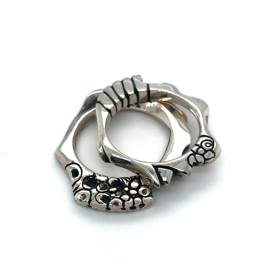 Pair of cast sterling silver rings.