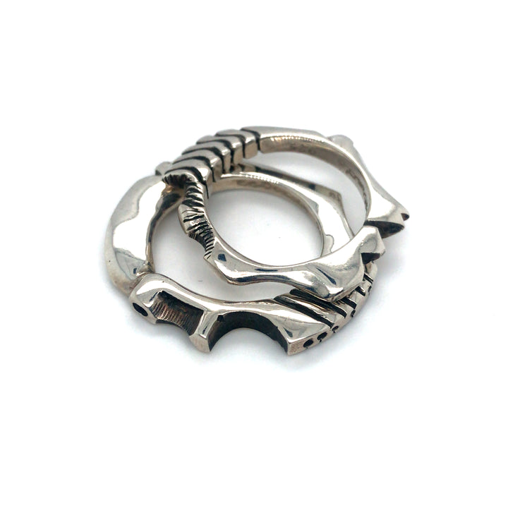 Pair of cast sterling silver rings.