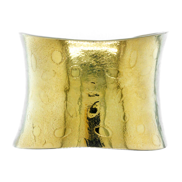 Gold plated brass cuff patterned with small oval dots. 