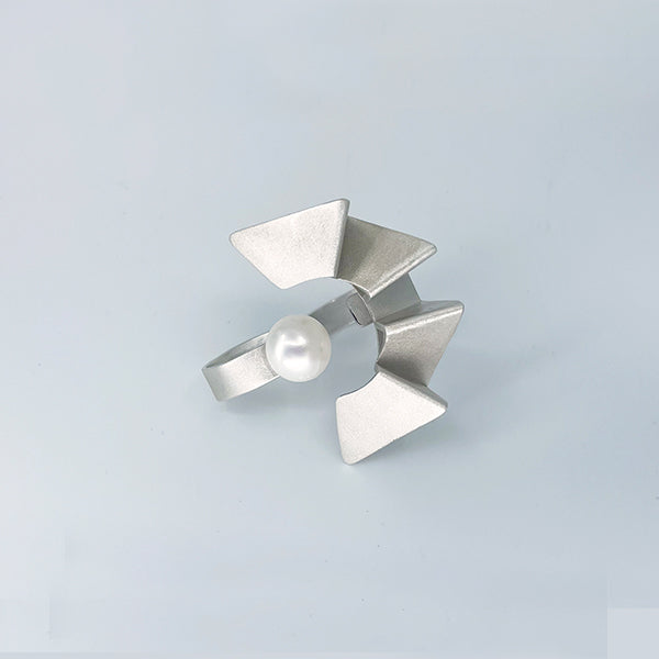 Human progress double finger ring, 2022.  Hand fabricated sterling silver ring with a 12mm pearl. This piece can be rotated for two different looks.