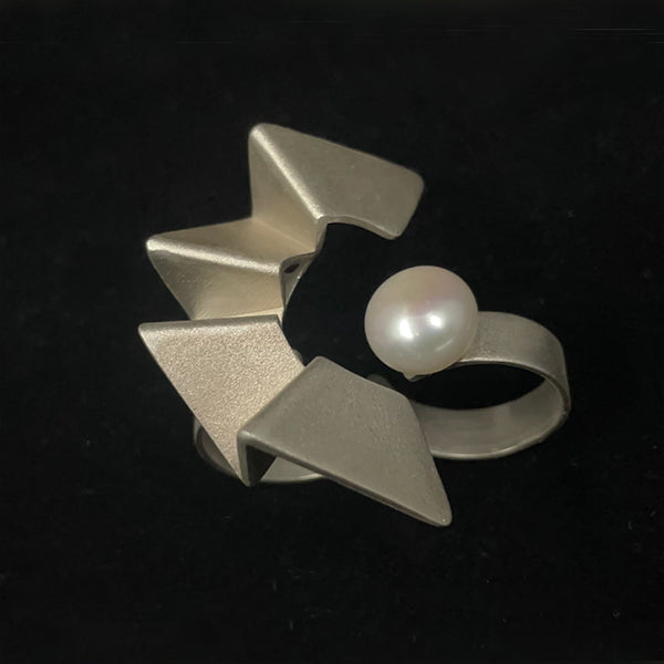 Human progress double finger ring, 2022.  Hand fabricated sterling silver ring with a 12mm pearl. This piece can be rotated for two different looks.