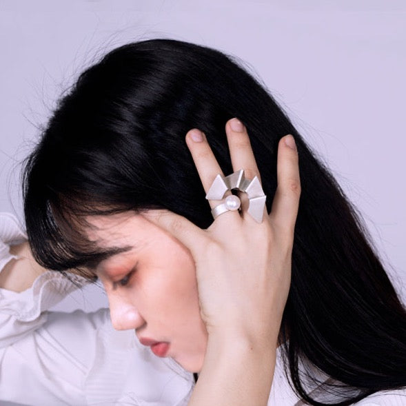 Human progress double finger ring, 2022.  Hand fabricated sterling silver ring with a 12mm pearl. This piece can be rotated for two different looks.