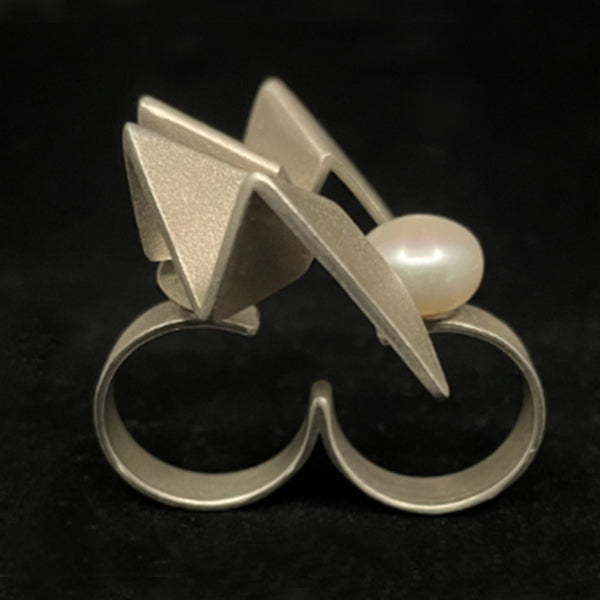 Human progress double finger ring, 2022.  Hand fabricated sterling silver ring with a 12mm pearl. This piece can be rotated for two different looks.