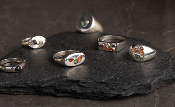 Bague Dôme: Sterling silver band with a rough sapphire. Pictured at left.