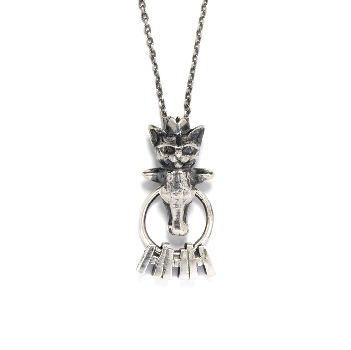 Eloi Necklace: From the Nous Les Animaux series, a small sterling silver pendant of a cat head and a cow's head. The cat's head is capped with a crown. The hoops is moveable.