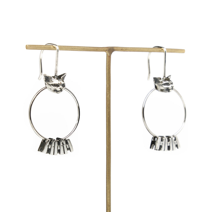 Romane Earrings: From the Nous Les Animaux series, a silver hoop hangs from a small cat head.