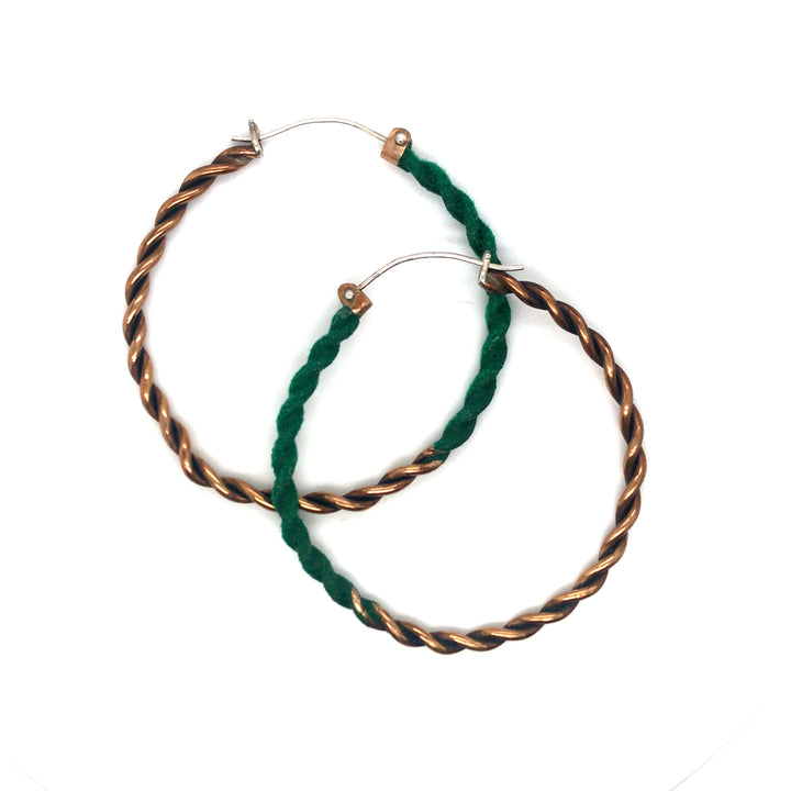 Large twisted and green-flocked bronze hoops on sterling silver ear wires. They measure 5.5 x 5 x.5 cm.
