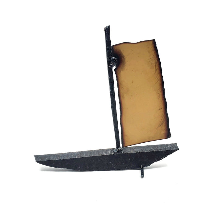 Bateau - Small red boat of welded repurposed iron. The sail is red on one side, and orange on the other.