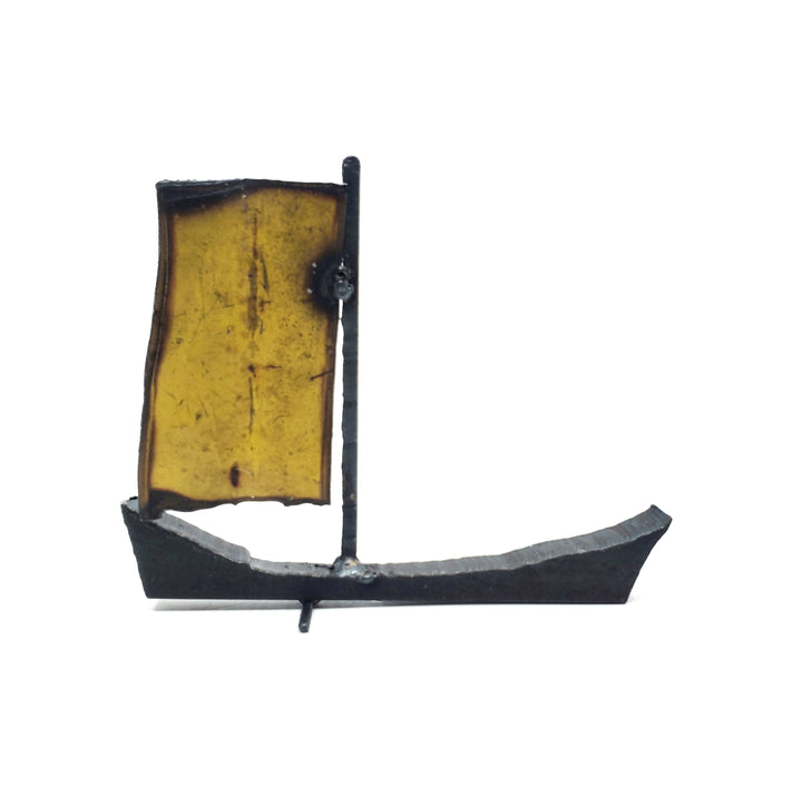 Bateau - Small yellow boat of welded repurposed iron. The sail is yellow on one side, and off-white on the other.
