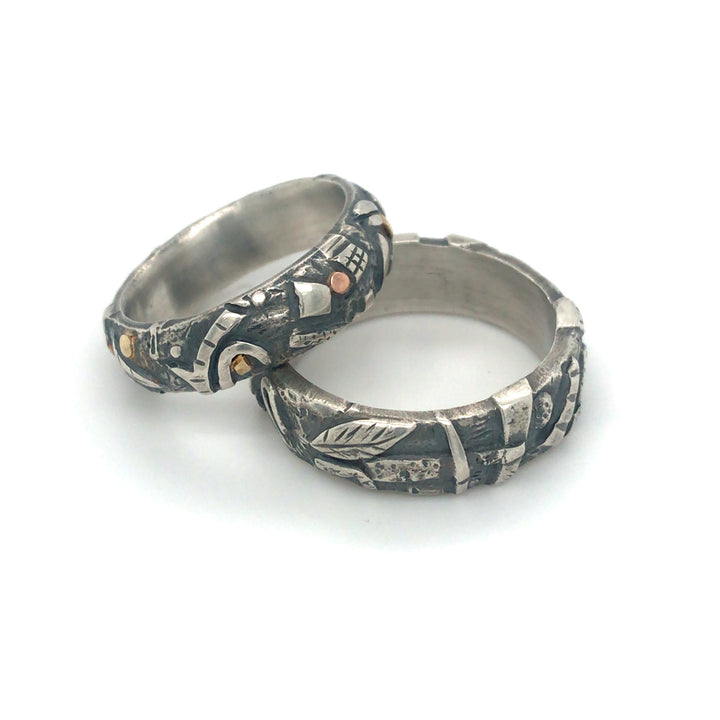 "Forest floor" ring of sterling silver, with oxidization and 14k/18k details. The shapes of branches, leaves and stones fully surround the 6mm band. Size 7.75
