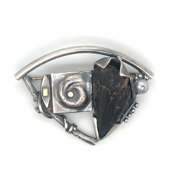Fossilized shark's tooth set in sterling silver with gold details and a grey pearl, 5x3x1 cm.