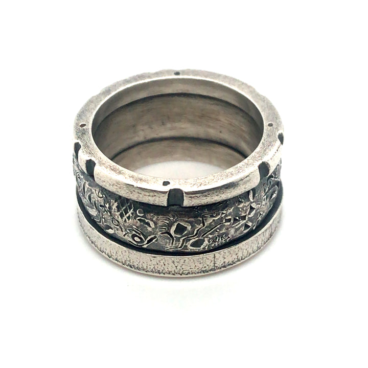 A handsome sterling silver stacked ring that combines three bands in one. A size 7.5 and 0.5 cm wide, this unisex ring is a strong combination of texture and geometry.