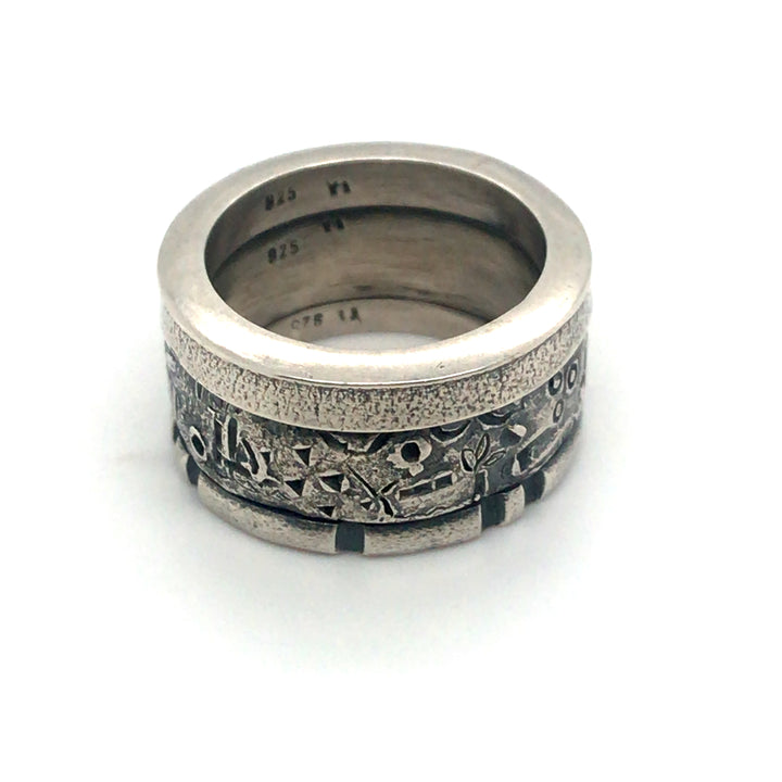 A handsome sterling silver stacked ring that combines three bands in one. A size 7.5 and 0.5 cm wide, this unisex ring is a strong combination of texture and geometry.
