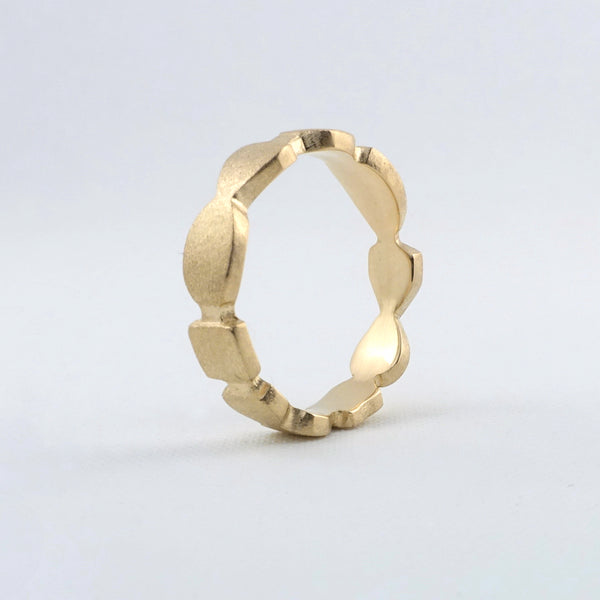 Abstract Cutouts ring in 14k yellow gold. The 4mm band has a soft brushed finish.