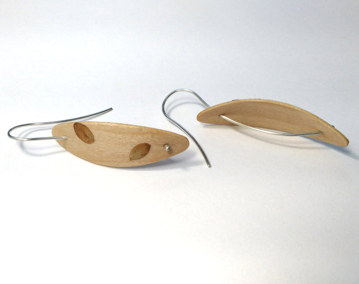 Maple Foraged Pod earrings, 2023. Hand laminated and bent maple wood earrings with sterling silver and foraged plant material.