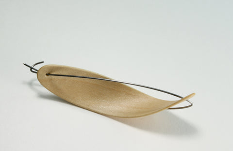 Curled Pod brooch 1, 2018. Laminated bent maple wood and stainless steel.