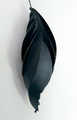 Patinated Silver Reimagining Blombos pendant, 2021. Sterling silver with nylon cord.