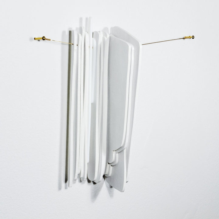 Keys use manipulated imagery of reflections found throughout the home in constructions of water jet cut glass and laser cut wood connected with brass coloured wire. They investigate domestic space and its significance. 