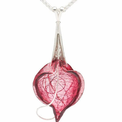 The Breath pendant is made with sterling silver, dyed resin, and thread with a 24" wheat chain.