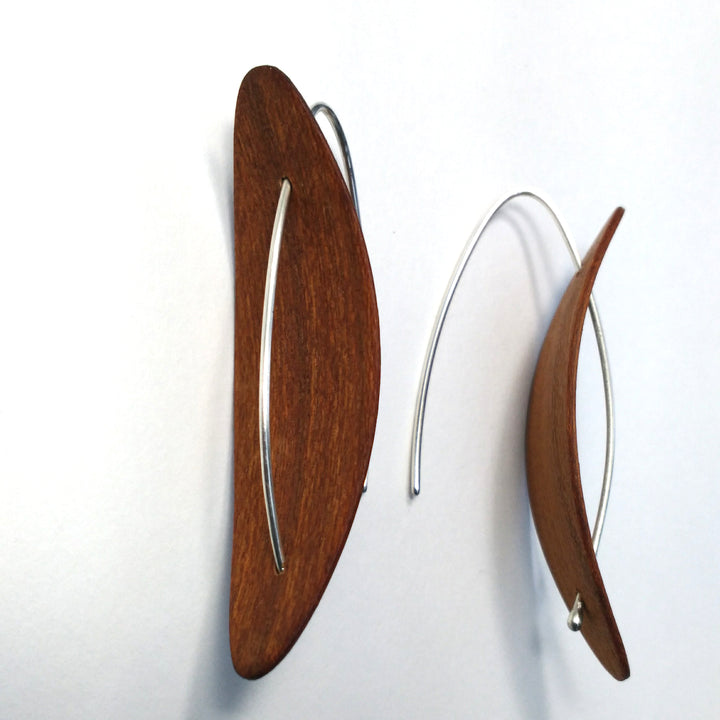 Medium Reverse Pod cherry earrings, 2023. Hand laminated, bent, and oiled cherry wood earrings, with sterling silver hooks.
