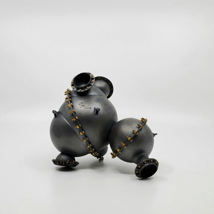 Industrial Cloud # 15. An intriguing abstract small scale sculpture that is a hollow hand fabricated copper vessel. The drilled and screwed tiny bolts suggest the tight locking of numerous parts into place forms.  It measures 18 x 9 x 13 cm with various resting positions. 
