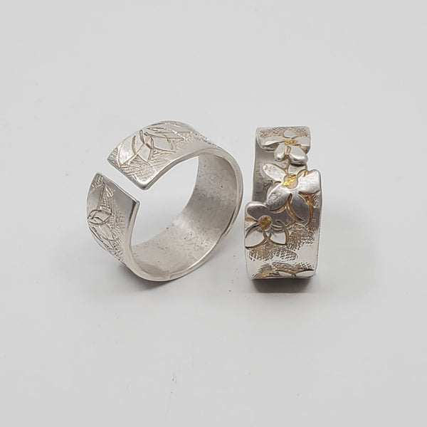Hand-tooled sterling silver rings, with keumboo gold worked into the flowers in the ring on the right ($118). Their open structure allows both rings to be slightly adjusted. Ring on left,  $110.  