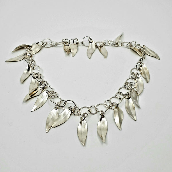 Multiple sterling silver leaves flash and sparkle with movement like leaves caught by sunlight on this super- feminine necklace. 
